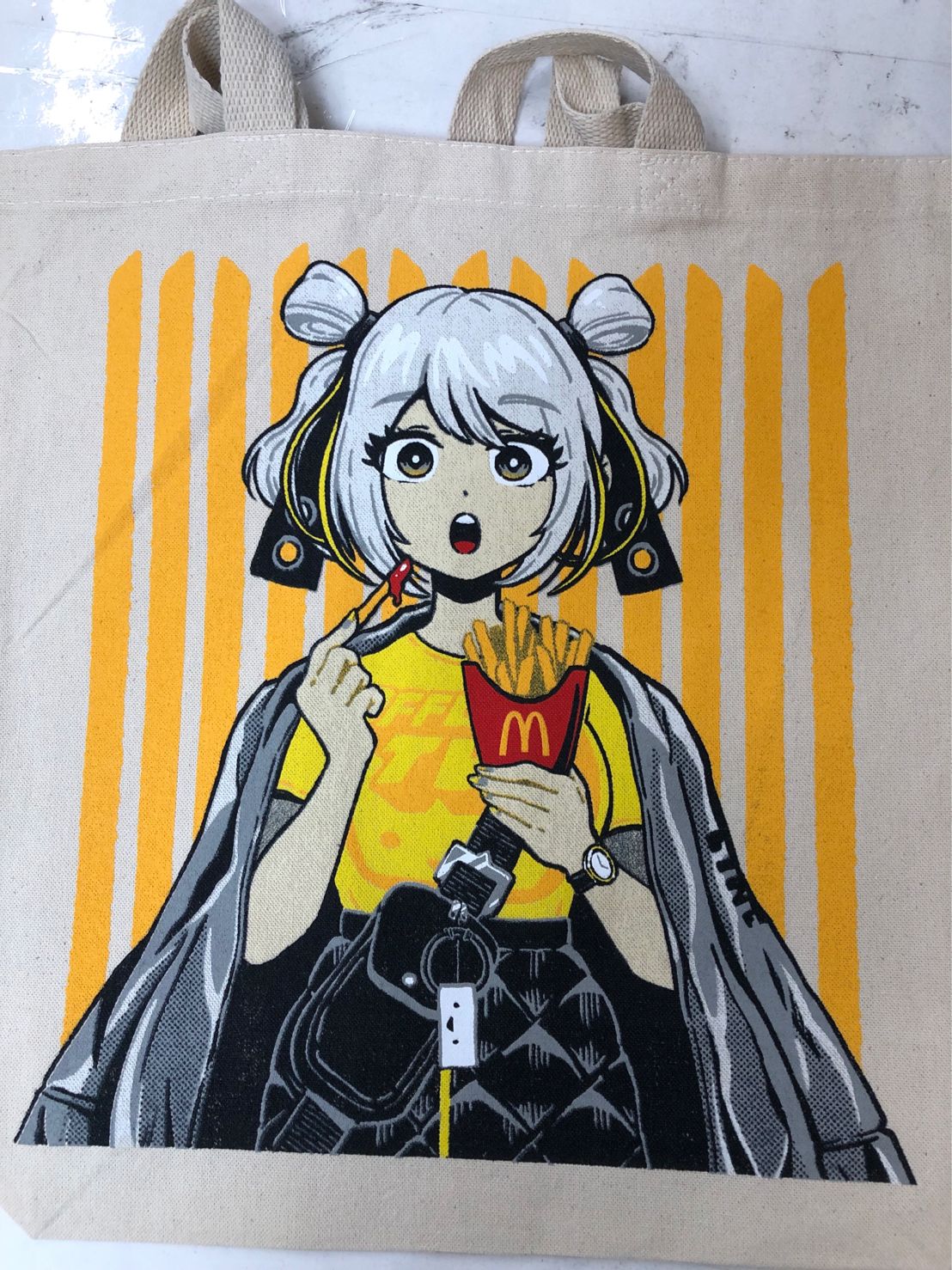 Custom McDonalds Tote bag with an illustration of a character eating fries against a yellow striped background